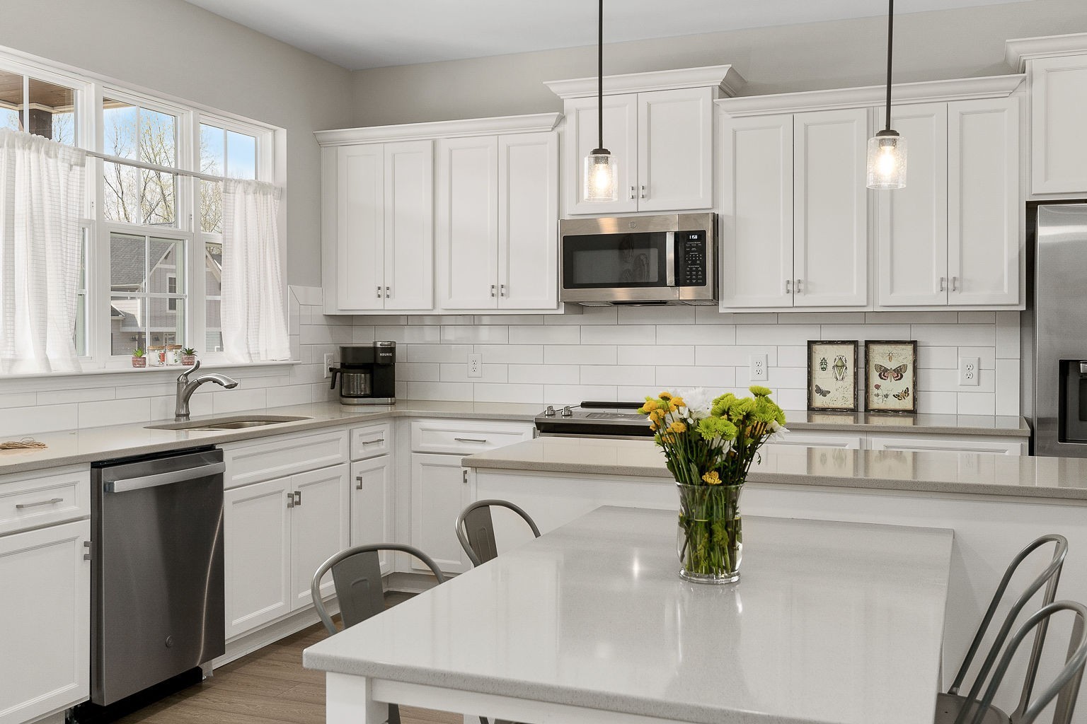 324 Evans Drive Tullahoma, TN 37388 - Photo 12 of 53 a kitchen with stainless steel appliances a sink a white cabinets wooden floor and a window