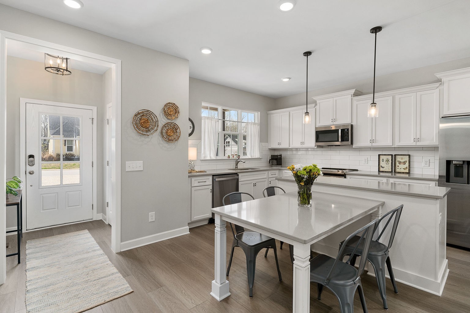 324 Evans Drive Tullahoma, TN 37388 - Photo 15 of 53 a kitchen with stainless steel appliances kitchen island granite countertop a dining table chairs and white cabinets