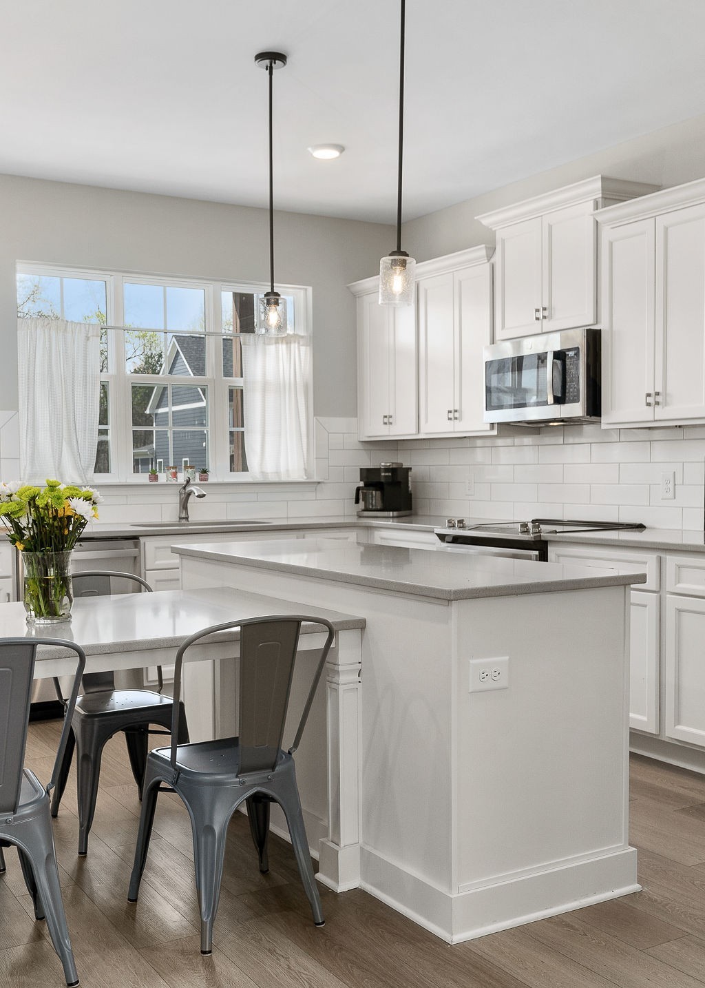 324 Evans Drive Tullahoma, TN 37388 - Photo 16 of 53 a kitchen with stainless steel appliances granite countertop a stove a sink dishwasher a microwave oven with white cabinets and wooden floor