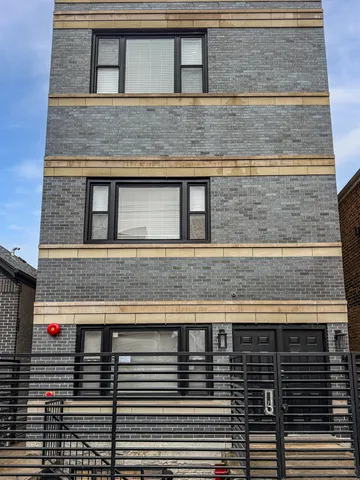 a kitchen with granite countertop a sink cabinets and wooden floor