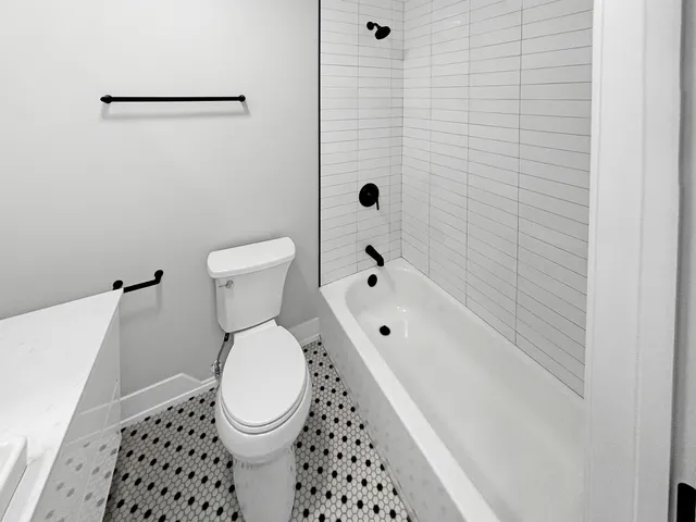 a bathroom with a shower and a sink