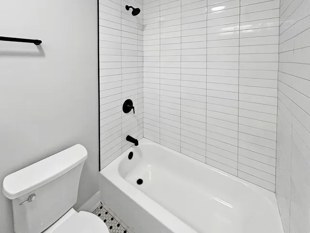 a bathroom with a toilet and a shower curtain