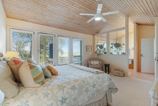 a bedroom with a large bed and a large window