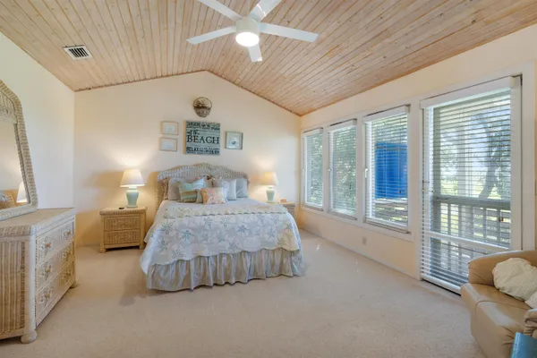 a bedroom with a bed and a large window