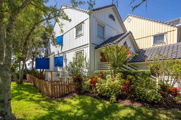 a view of a house with wooden fence