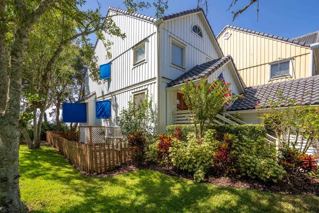 a view of a house with wooden fence