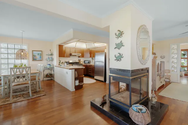 a living room with furniture a table and kitchen view
