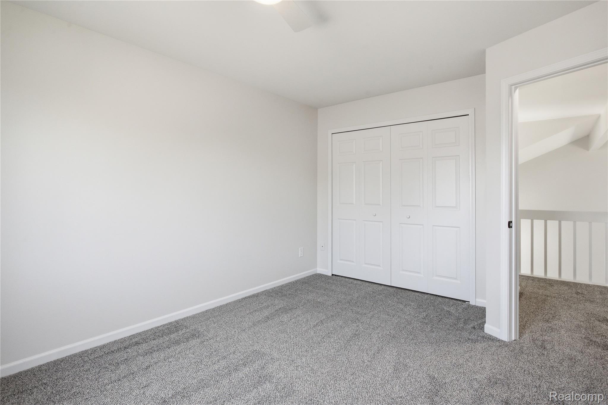 52658 Stag Ridge Drive Macomb, MI 48042 - Photo 23 of 28 Spacious room featuring neutral carpeting, a dual bi-fold closet, and crisp white walls
