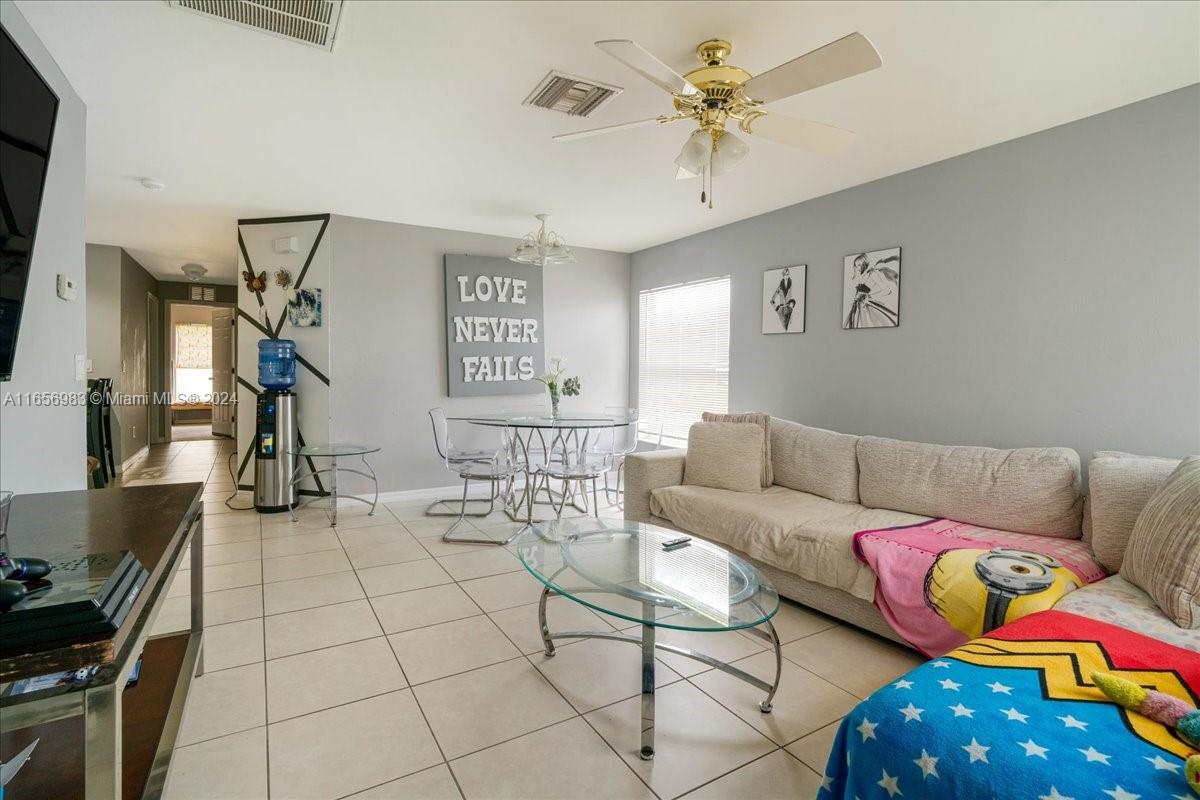 3978 Sunset Road Lehigh Acres, FL 33971 - Photo 23 of 42 a living room with furniture and a flat screen tv