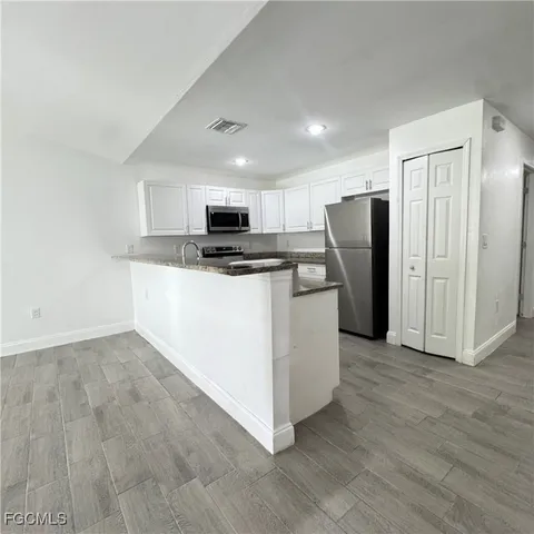 a kitchen with stainless steel appliances a refrigerator stove microwave and sink