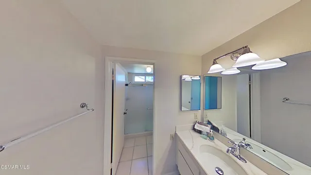 a bathroom with a sink vanity and mirror