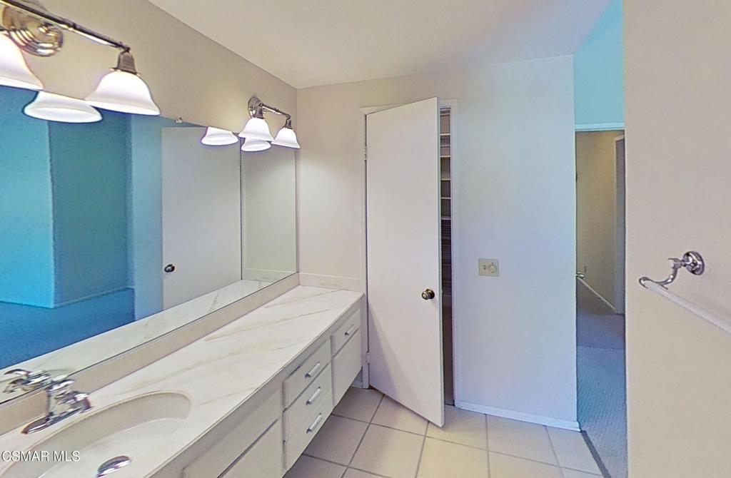 205 Larkhill Street Thousand Oaks, CA 91360 - Photo 15 of 26 a bathroom with a sink a mirror and a light fixture