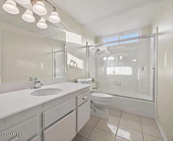 a bathroom with a granite countertop sink mirror toilet and shower