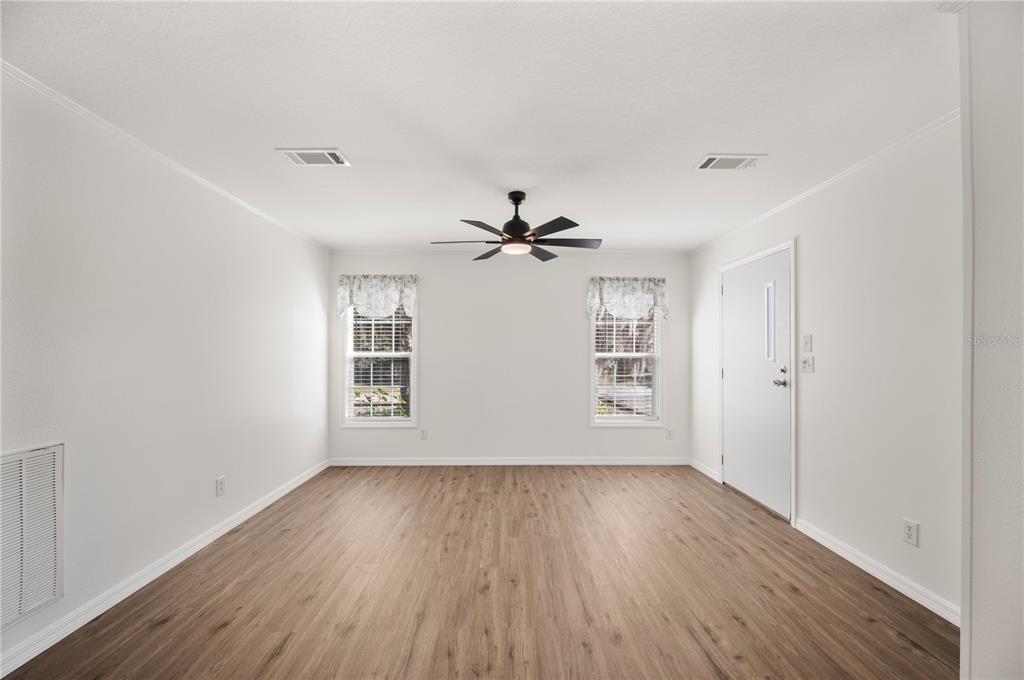 4900 J Jackson Road Fort Meade, FL 33841 - Photo 13 of 97 wooden floor in an empty room with a window
