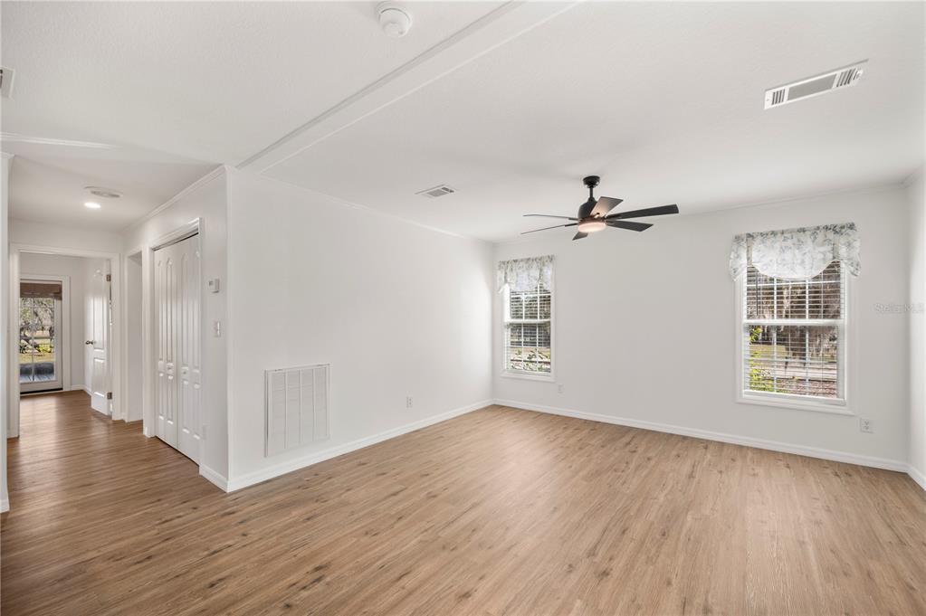 4900 J Jackson Road Fort Meade, FL 33841 - Photo 14 of 97 a view of an empty room with wooden floor and a window