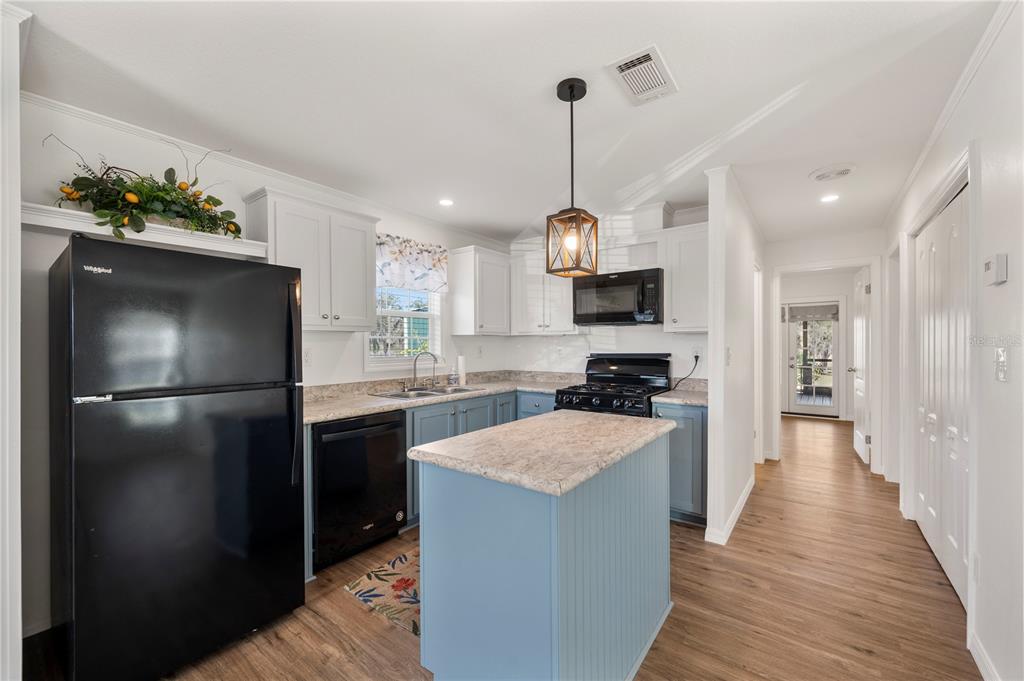 4900 J Jackson Road Fort Meade, FL 33841 - Photo 15 of 97 a kitchen with kitchen island a counter top space a sink stainless steel appliances and cabinets