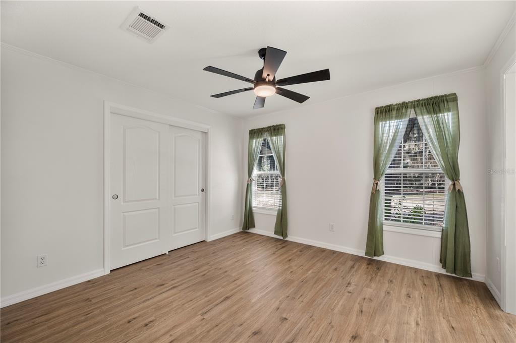 4900 J Jackson Road Fort Meade, FL 33841 - Photo 20 of 97 wooden floor in an empty room with a window