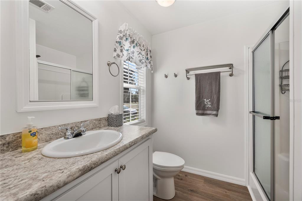 4900 J Jackson Road Fort Meade, FL 33841 - Photo 22 of 97 a bathroom with a granite countertop sink a toilet and a mirror