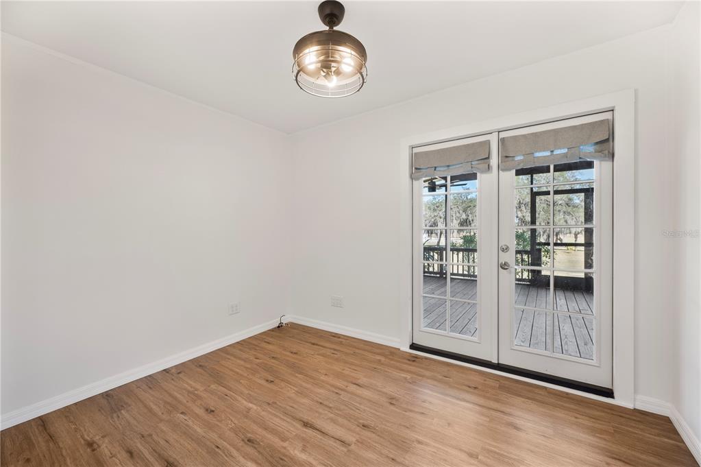4900 J Jackson Road Fort Meade, FL 33841 - Photo 26 of 97 an empty room with wooden floor and windows
