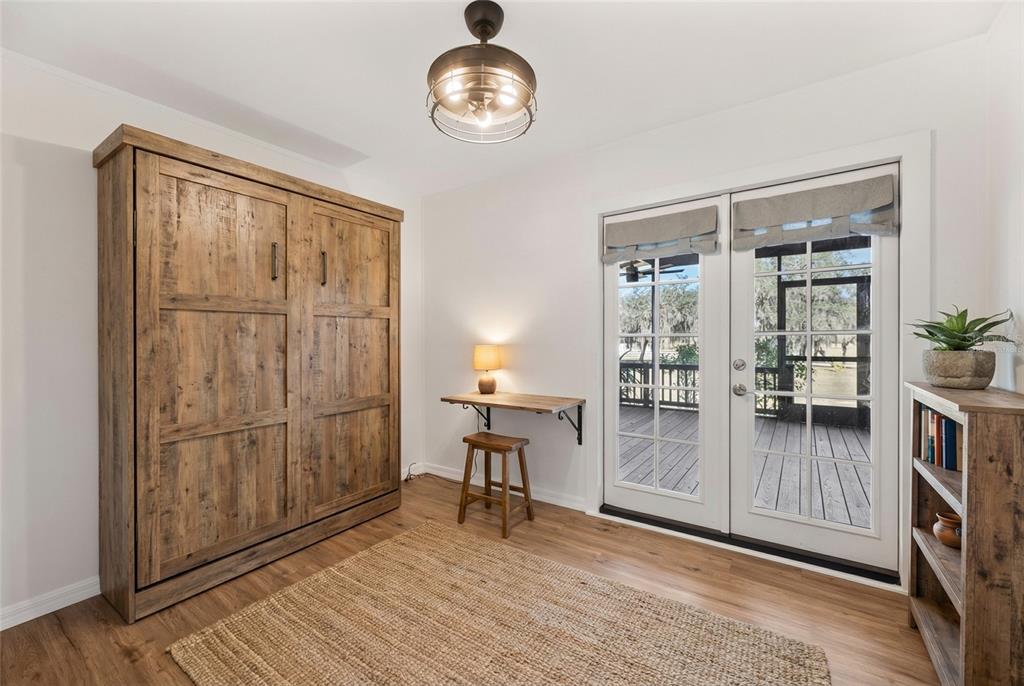 4900 J Jackson Road Fort Meade, FL 33841 - Photo 27 of 97 wooden floor in an empty room with a window