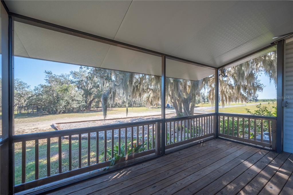4900 J Jackson Road Fort Meade, FL 33841 - Photo 29 of 97 a view of a two room with wooden floor and iron stairs