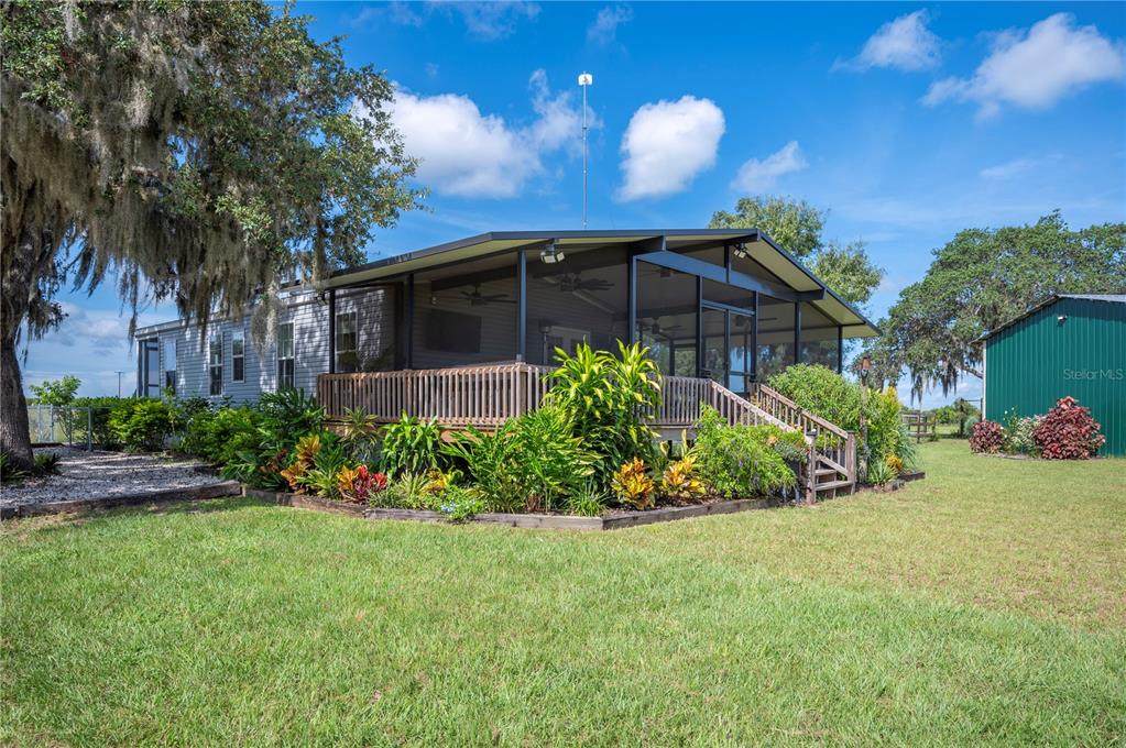4900 J Jackson Road Fort Meade, FL 33841 - Photo 35 of 97 a front view of a house with a yard and potted plants