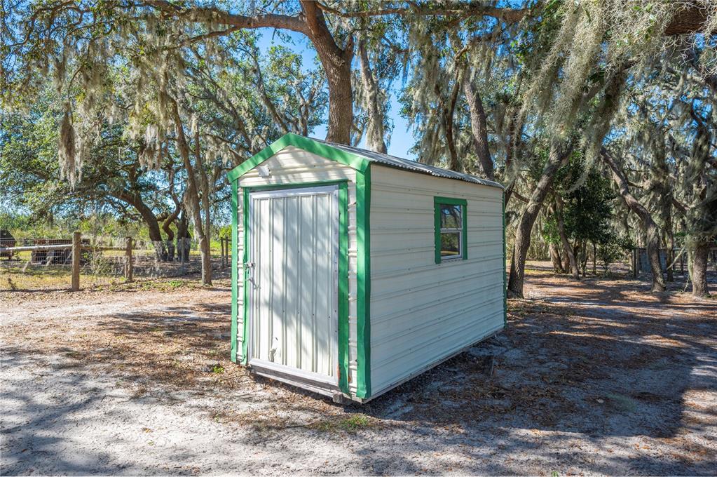 4900 J Jackson Road Fort Meade, FL 33841 - Photo 64 of 97 a view of a backyard with large trees and wooden fence