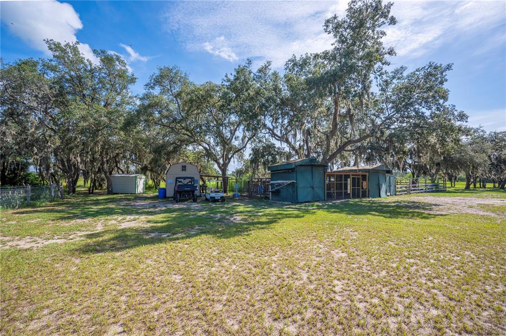 4900 J Jackson Road Fort Meade, FL 33841 - Photo 66 of 97 a view of a house with a yard and large trees