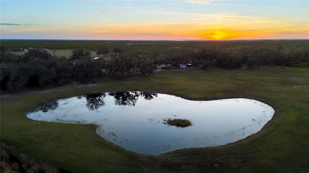 4900 J Jackson Road Fort Meade, FL 33841 - Photo 86 of 97 a view of a lake with a yard and mountain view