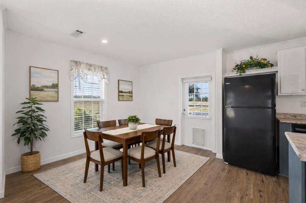 4900 J Jackson Road Fort Meade, FL 33841 - Photo 10 of 97 a view of a dining room with furniture window and wooden floor