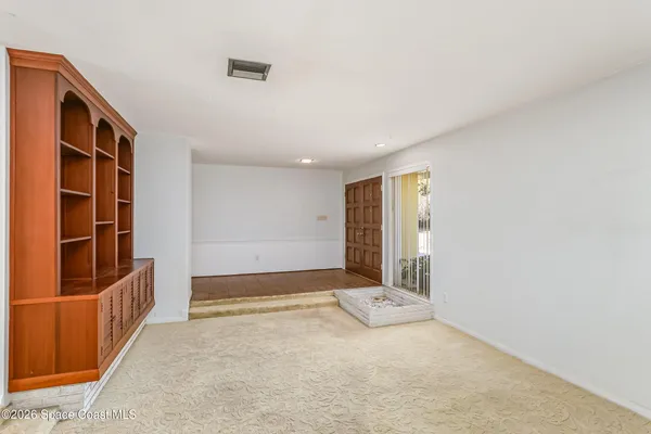 a picture of a room that has a rug on it and of it