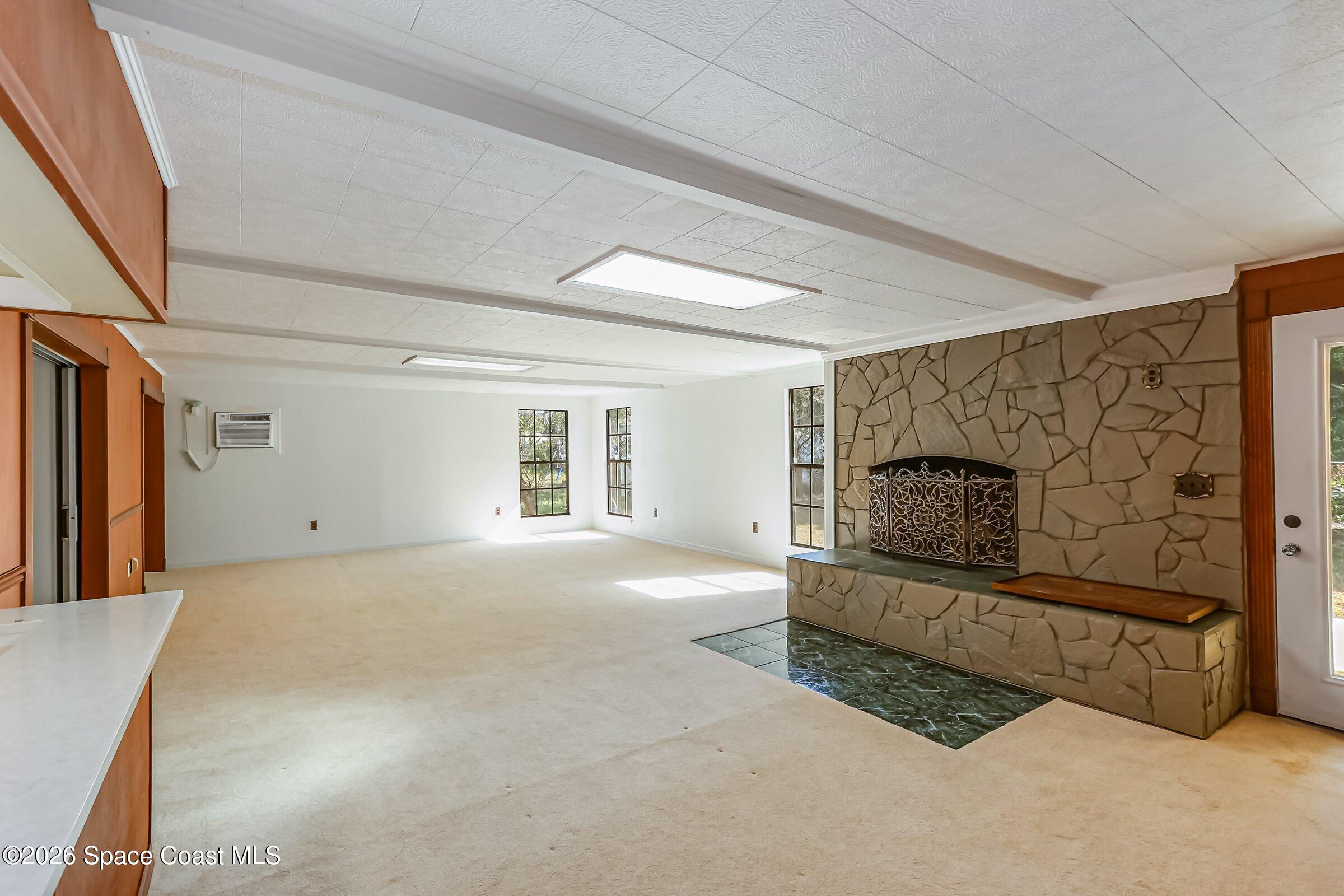 1275 Troon Way Rockledge, FL 32955 - Photo 27 of 61 a living room with furniture a flat screen tv and a fireplace