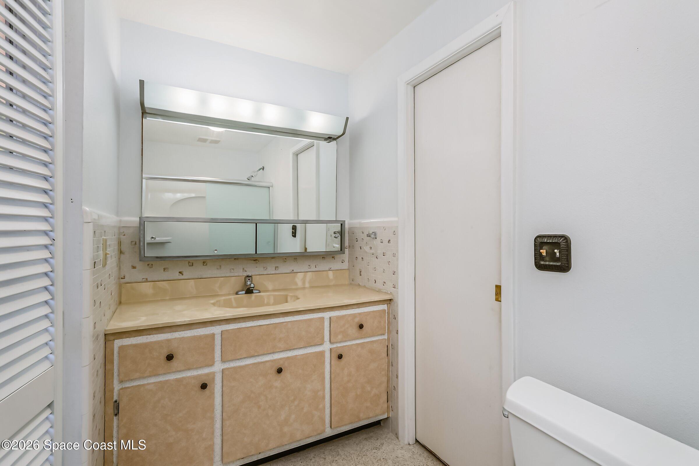 1275 Troon Way Rockledge, FL 32955 - Photo 38 of 61 a bathroom with a sink toilet and tub