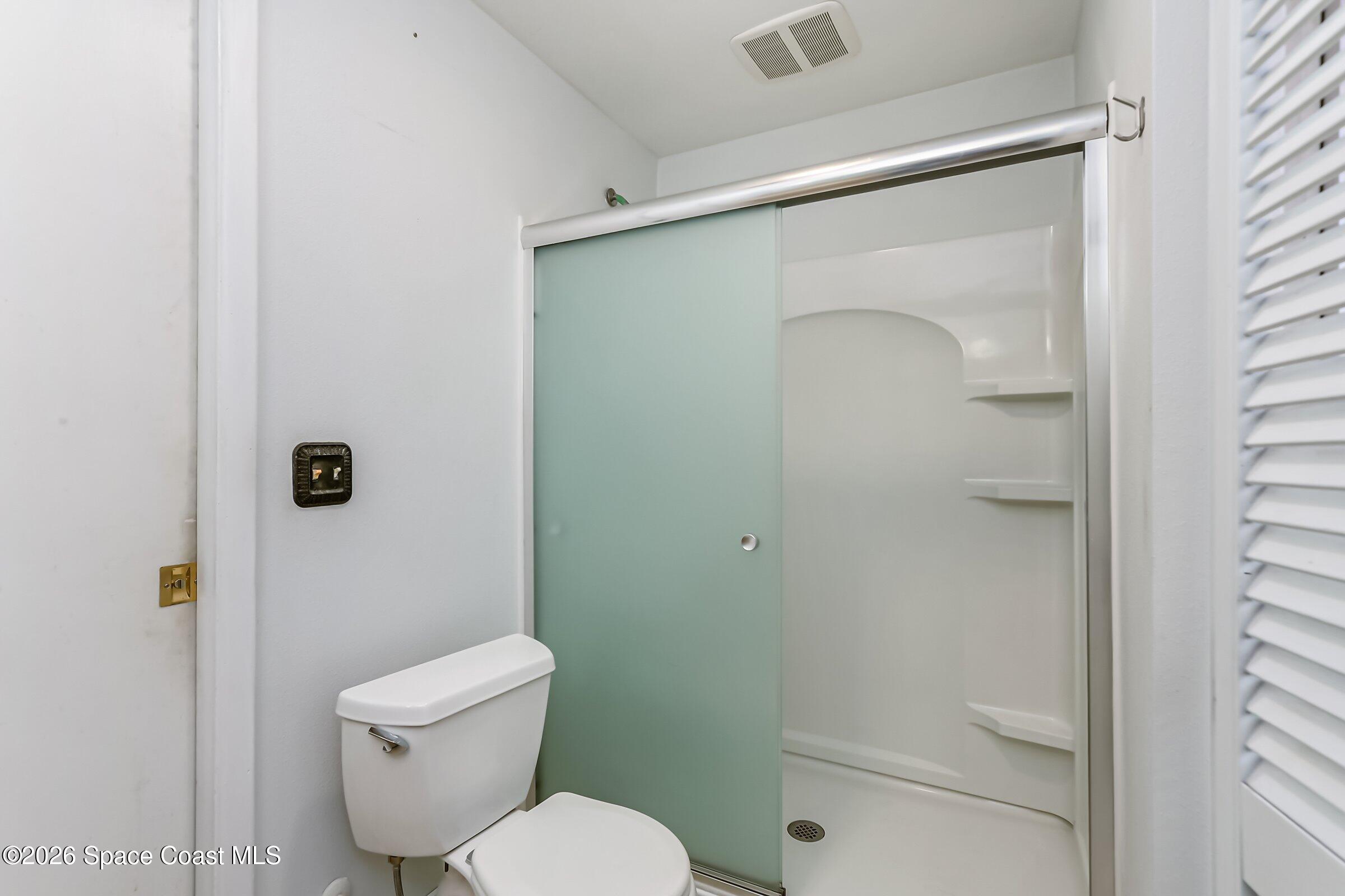 1275 Troon Way Rockledge, FL 32955 - Photo 39 of 61 a white toilet sitting next to a bathroom sink