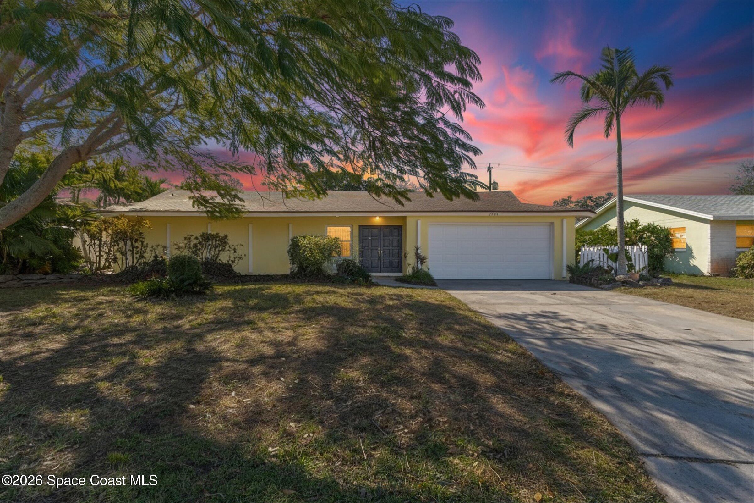 1275 Troon Way Rockledge, FL 32955 - Photo 42 of 61 a front view of a house with a garden and tree