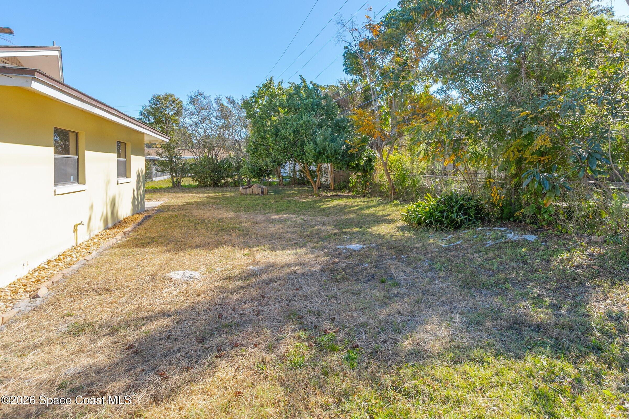 1275 Troon Way Rockledge, FL 32955 - Photo 50 of 61 a view of a yard with plants and trees
