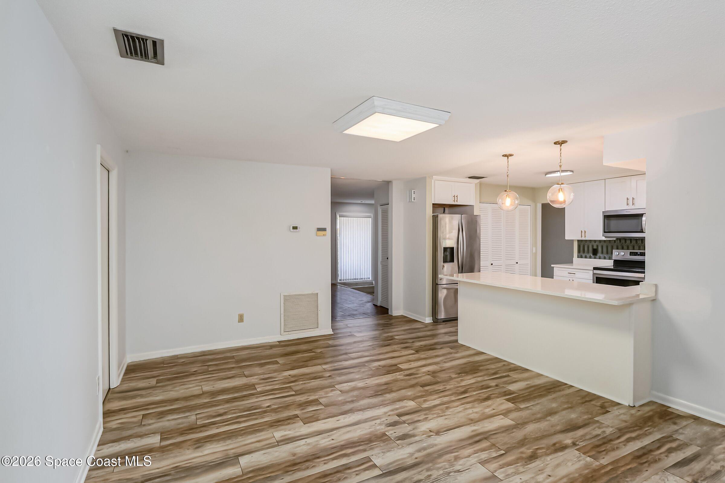 1275 Troon Way Rockledge, FL 32955 - Photo 8 of 61 a view of kitchen view and wooden floor