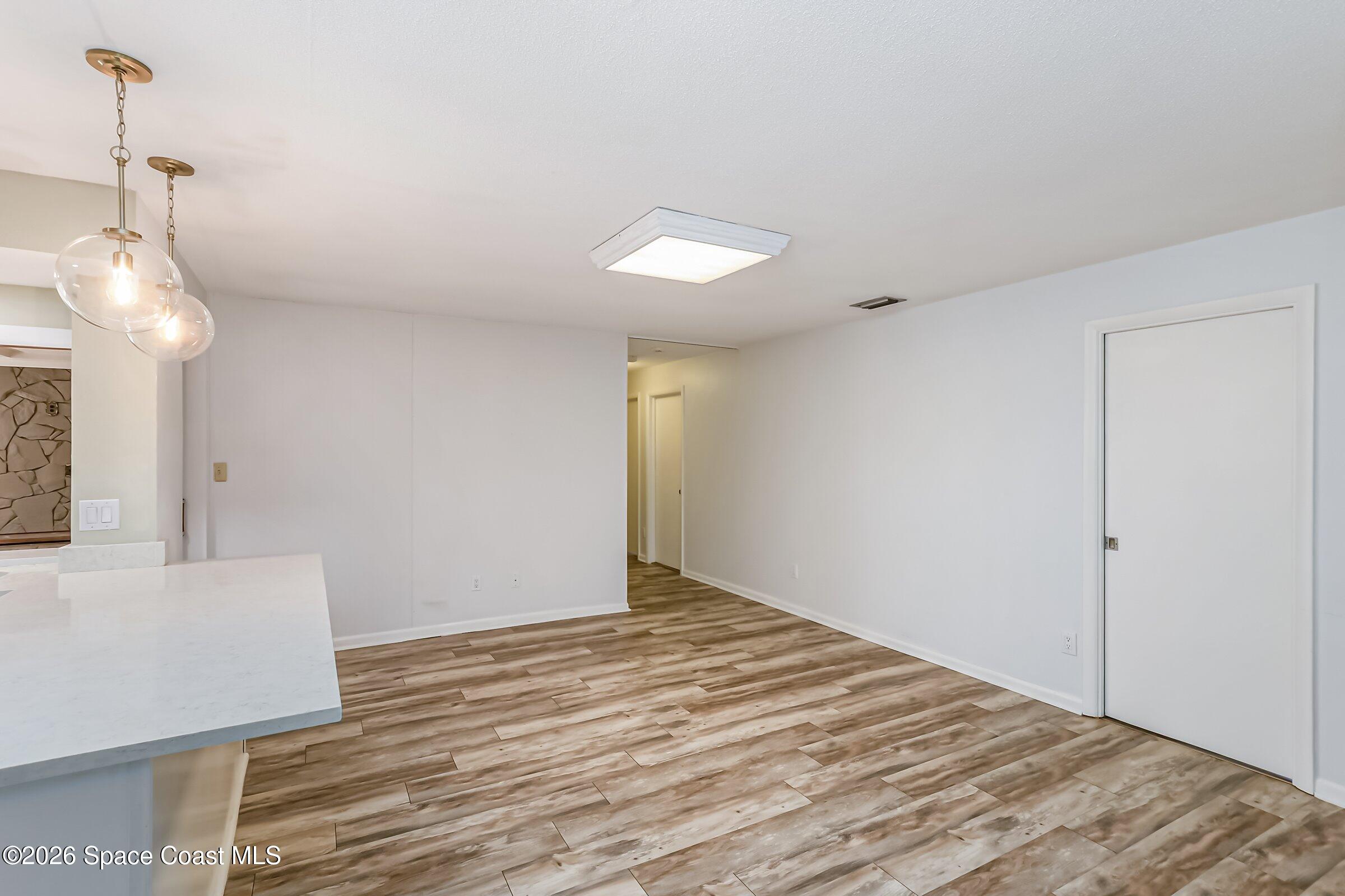 1275 Troon Way Rockledge, FL 32955 - Photo 9 of 61 a view of empty room with wooden floor