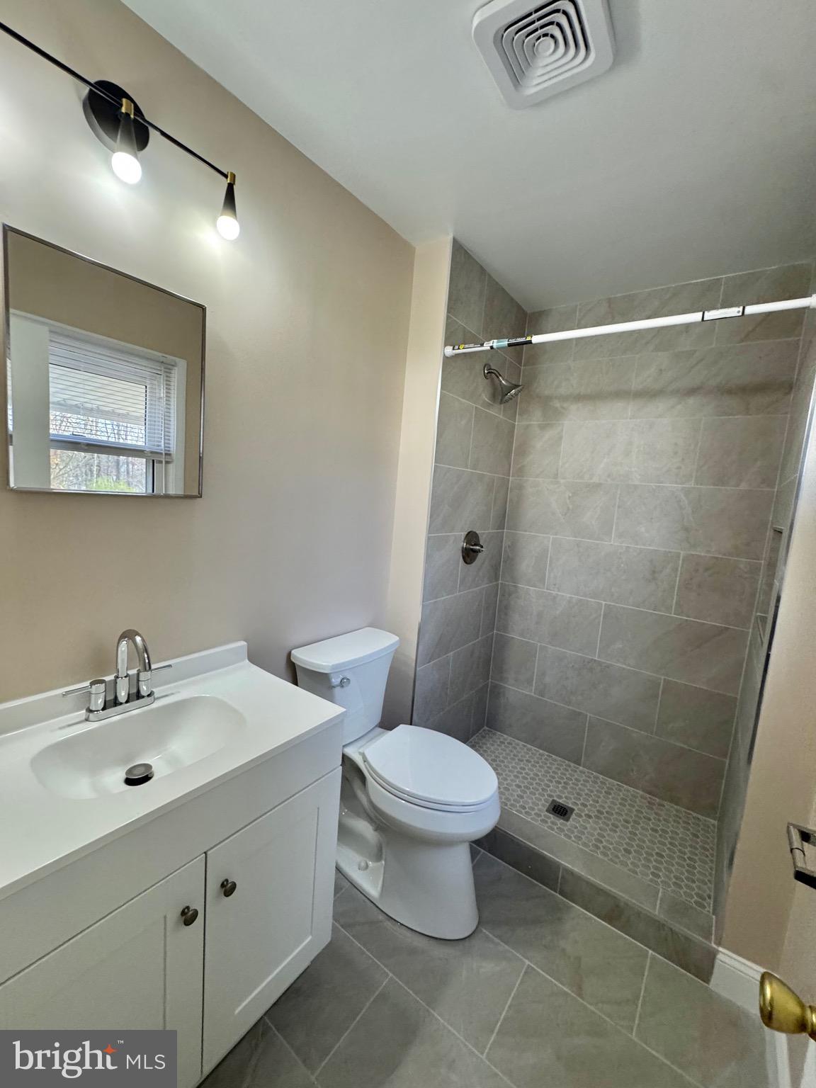 15758 Pointer Ridge Drive Bowie, MD 20716 - Photo 18 of 26 a bathroom with a sink mirror and toilet