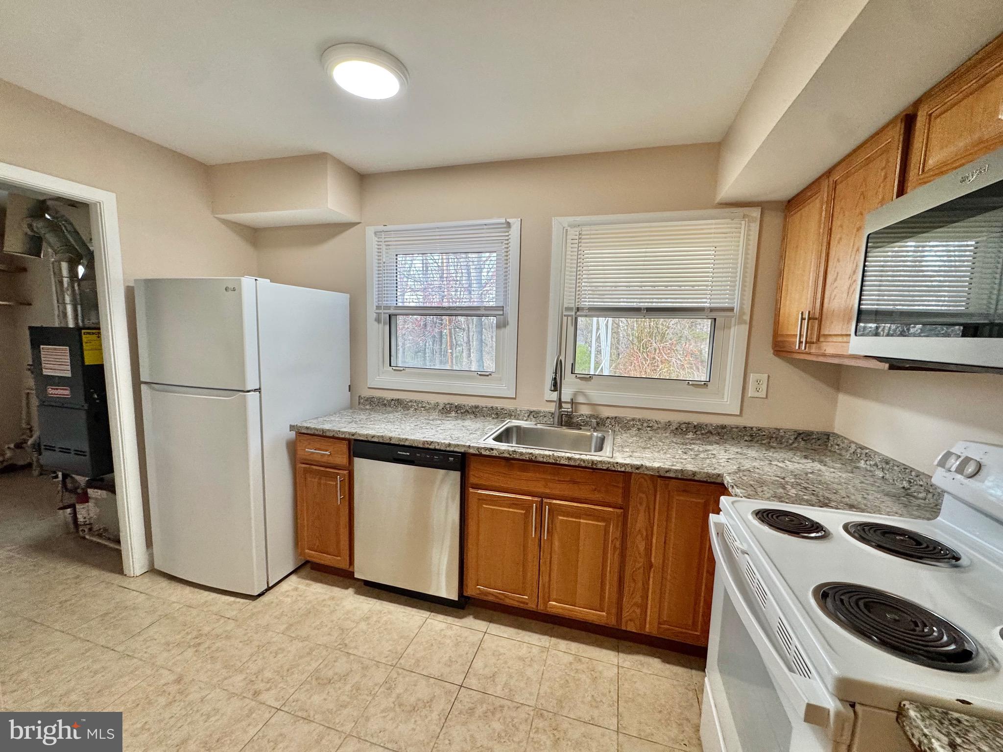 15758 Pointer Ridge Drive Bowie, MD 20716 - Photo 7 of 25 KITCHEN HAS DOOR ACCESS TO UTILITY ROOM & 4TH BR