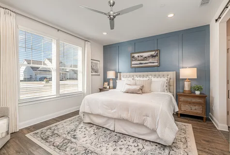 a bedroom with a large bed and a window