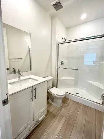 a view of kitchen and hall with wooden floor