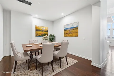 a view of a dining room with furniture and wooden floor