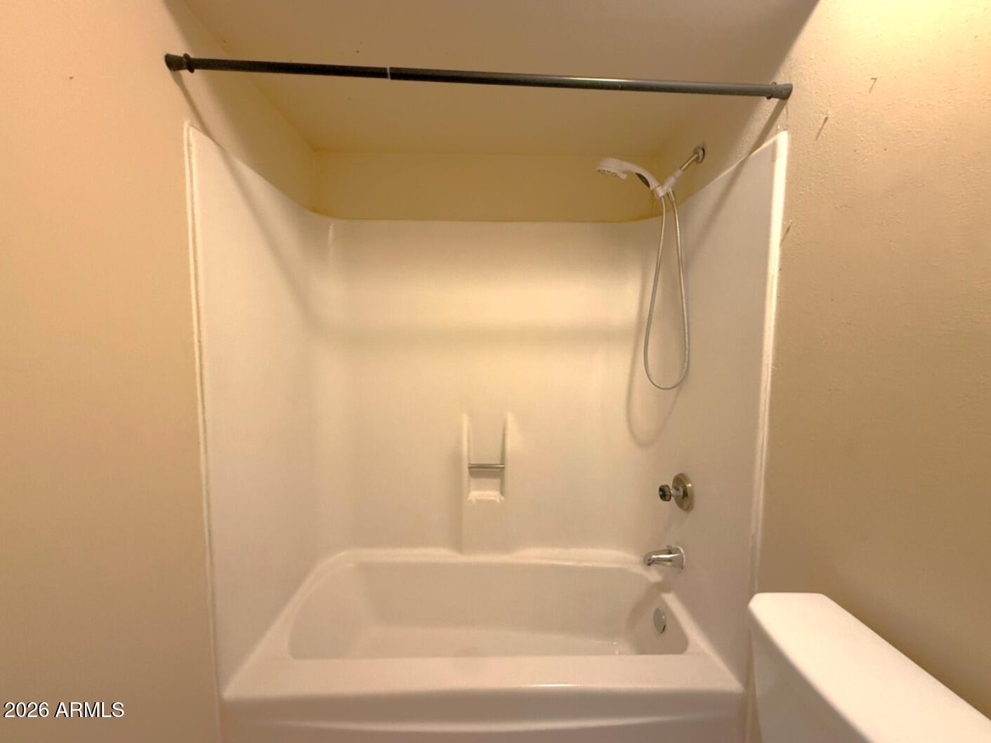 4625 South Rita Lane Tempe, AZ 85282 - Photo 13 of 16 a bathroom with a bathtub and a shower