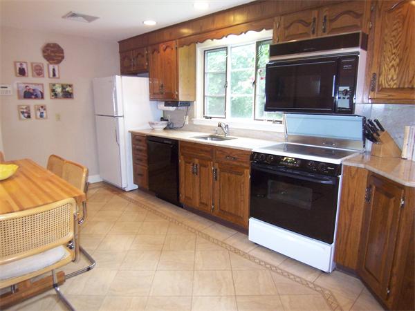 62 Judith Road Newton, MA 02459 - Photo 6 of 15 a kitchen with stainless steel appliances granite countertop a stove microwave and sink