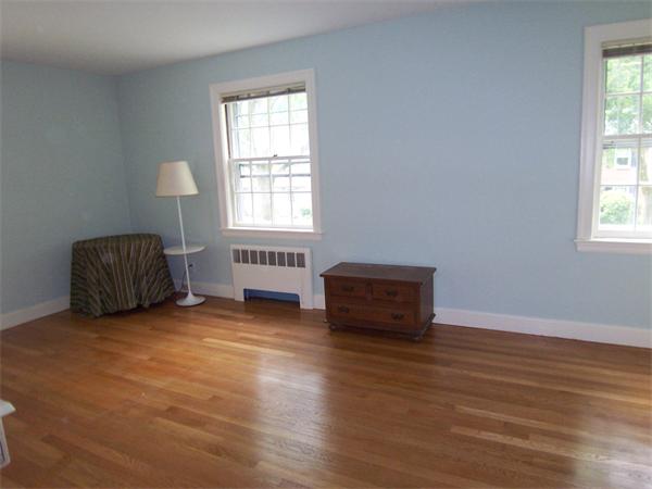 62 Judith Road Newton, MA 02459 - Photo 10 of 15 an empty room with wooden floor and windows