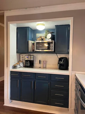 a kitchen with stainless steel appliances granite countertop a sink and cabinets