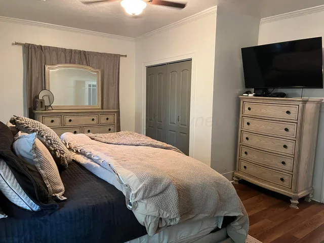 a bedroom with a bed and a flat screen tv