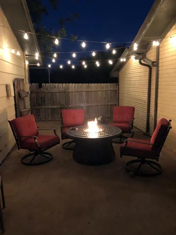 a living room with furniture a rug and a projector