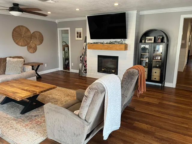 a living room with furniture fireplace and flat screen tv
